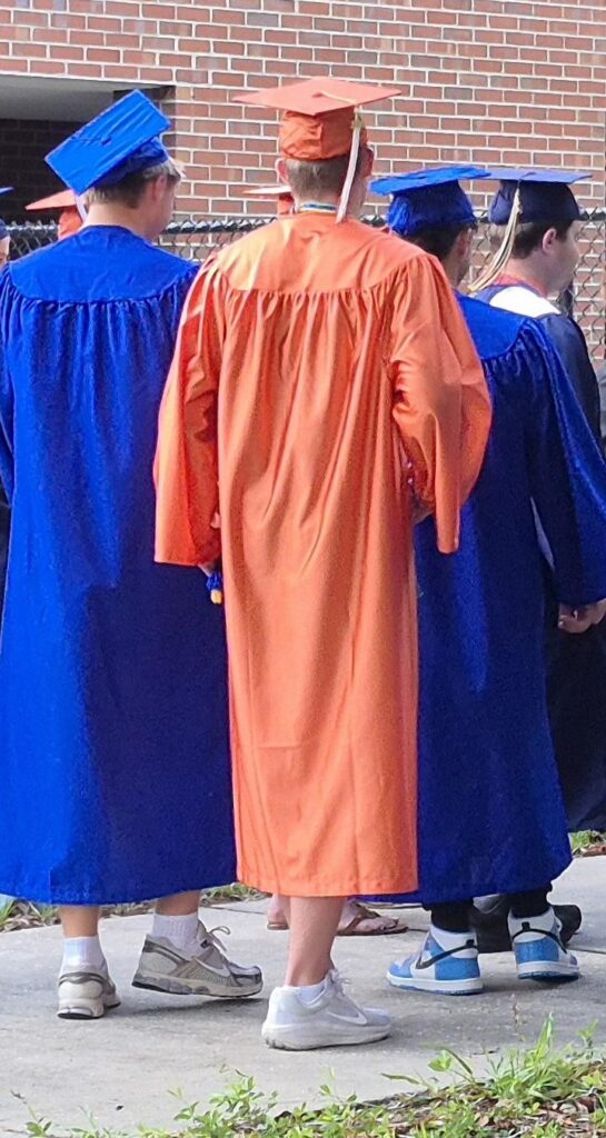 students graduating wearing cap and gown